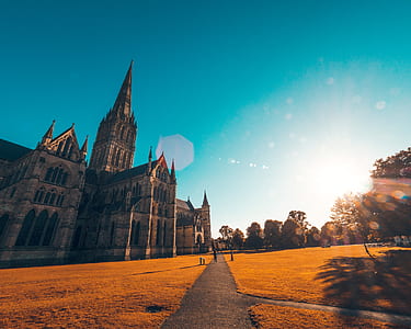 church near trees under blue and white sky thumbnail