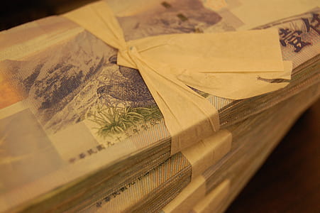 bundle of banknote on wood plank thumbnail