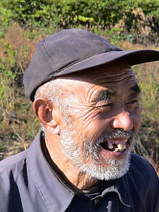 man wearing cap with broad smile outdoors thumbnail