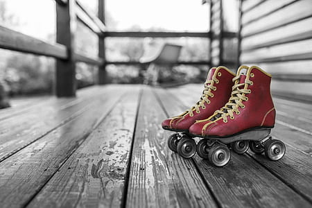 selective color photography of pair of red roller skates thumbnail