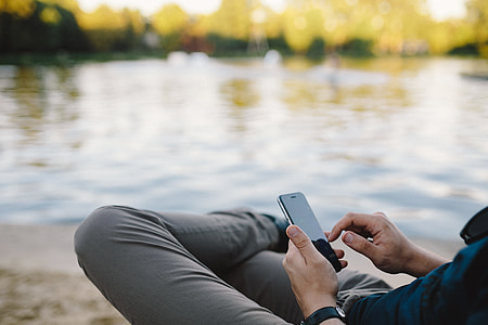 Young Man Using His Phone on beach thumbnail