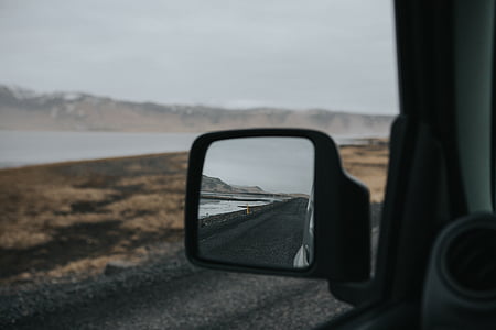 car left side mirror showing black road thumbnail