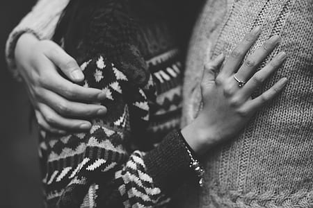 grayscale photo of woman hugging person thumbnail