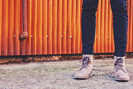 person standing near brown corrugated metal sheet thumbnail
