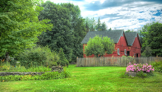 red and black painted house surrounded by green trees during daytime thumbnail