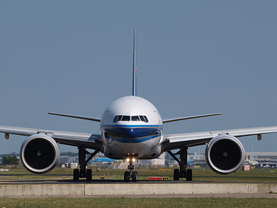 white and blue passenger airplane preparing to take-off thumbnail