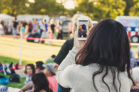 Woman Taking a Photo Outdoors thumbnail