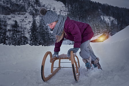 girl wearing gray scarf holding sled thumbnail