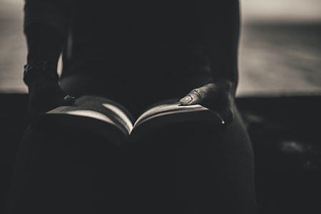 grayscale photography of person reading book thumbnail