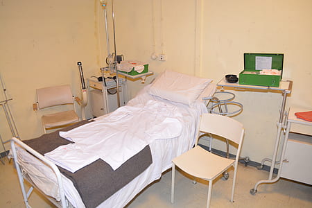 white and gray patient bed beside chair thumbnail