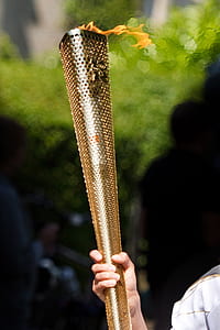 person holding brass-colored torch during daytime thumbnail