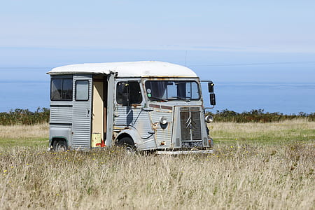 parked van on grass field thumbnail