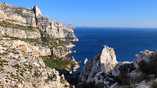 aerial photography of mountain and body of water thumbnail