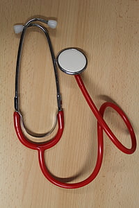 red and gray sphygmomanometer on beige wooden surface thumbnail