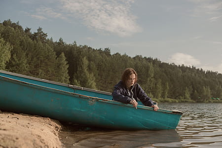 person on green boat thumbnail