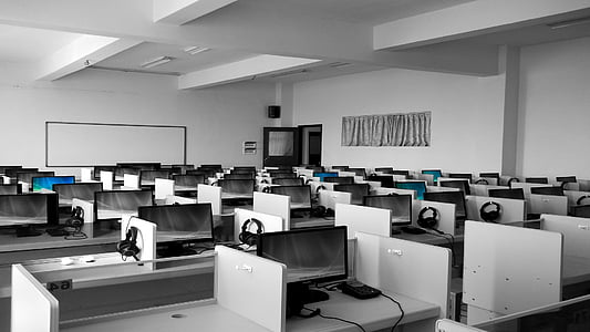 white office desks with black headsets thumbnail