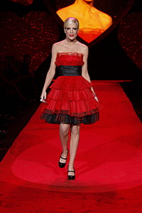 woman wearing red layered dress walking on runway thumbnail