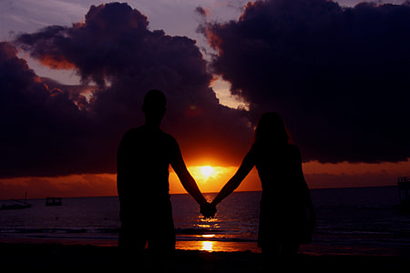 silhouette, two people, holding hands, sunset, beach, seaside thumbnail