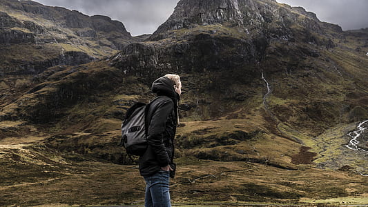man standing on mountain with mountain range background thumbnail
