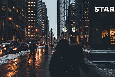 people walking on street beside high rise buildings thumbnail