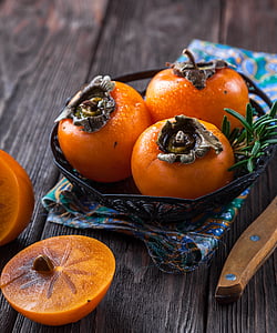 three round orange fruits on bowl thumbnail