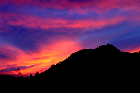 silhouette of mountain under blue and orange skies thumbnail