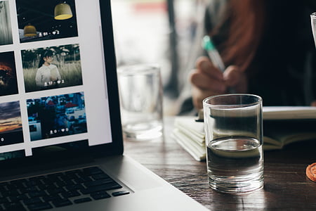 clear drinking glass near laptop computer thumbnail