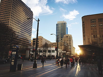 people walking on sidewalk under golden hour thumbnail