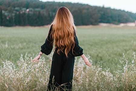 woman wearing black dress facing mountain thumbnail
