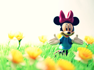 shallow focus photography of Minnie Mouse figure surrounded by yellow flowers thumbnail
