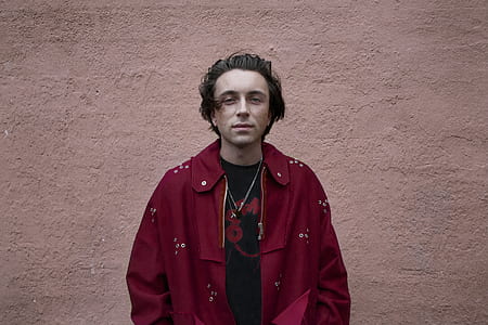 man wearing red collared top thumbnail