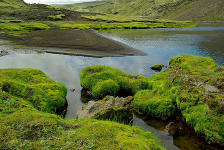 aerial photography of river between rocks with moss thumbnail