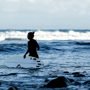 woman carrying surfboard thumbnail