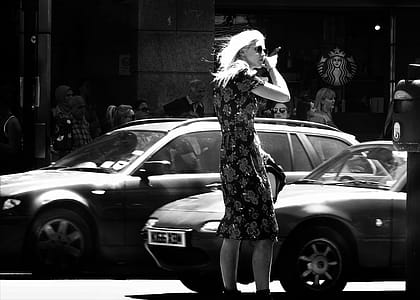 Woman Wearing Floral Short-sleeve Dress Standing Beside Car Grayscale Photo thumbnail