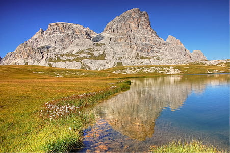 gray mountain and body of water at daytime thumbnail