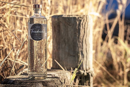 clear glass bottle on gray surface thumbnail