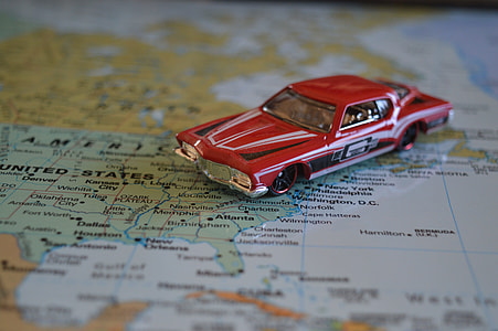 red muscle car die-cast scale model on map sketch thumbnail