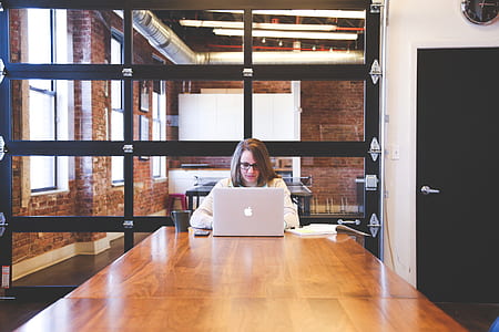 woman in white long-sleeved shirt using MacBook thumbnail