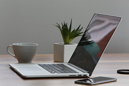 opened silver MacBook Pro beside mug thumbnail