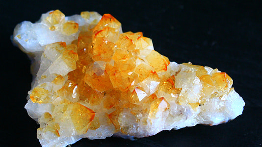 white and orange geode on black surface thumbnail