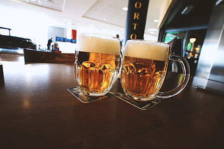 Two glasses of beer on a wooden table thumbnail