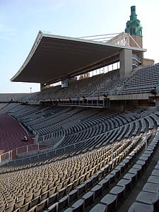 gray and red stadium under blue sky thumbnail