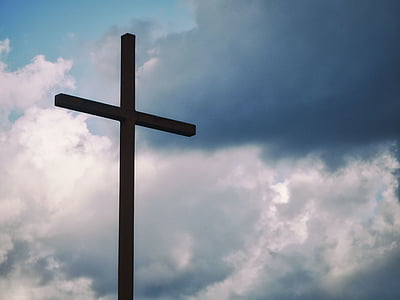 brown cross under gray clouds thumbnail