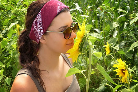 woman sniffing sunflower thumbnail