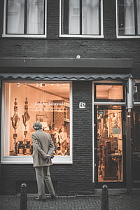 man standing in front of store with door close thumbnail