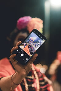 Person Taking Selfie to Black Android Smartphone thumbnail