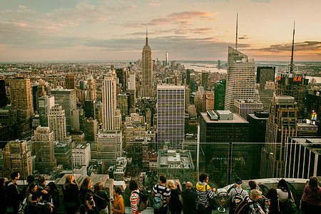 Tourists and sightseers gather on one of the Top Of The Rock observation decks at the Rockefeller Centre in Manhattan, New York City. The Empire State building can be seen in the background with views all the way down to Brooklyn and southern Manhattan thumbnail