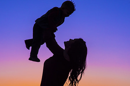 silhouette photo of woman carrying baby thumbnail