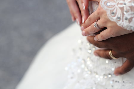 silver-colored band ring with clear gemstone on human hand thumbnail