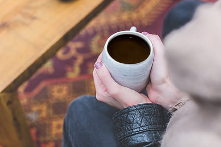 person holding white mug thumbnail